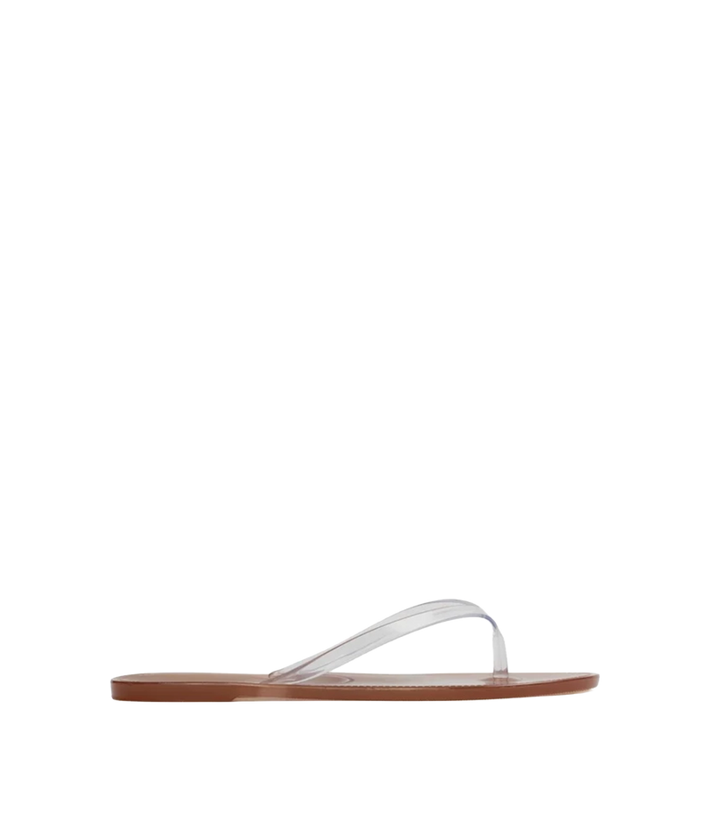 A single flat thong sandal shown in side profile, the sandal features a clear, transparent strap and a brown sole.
