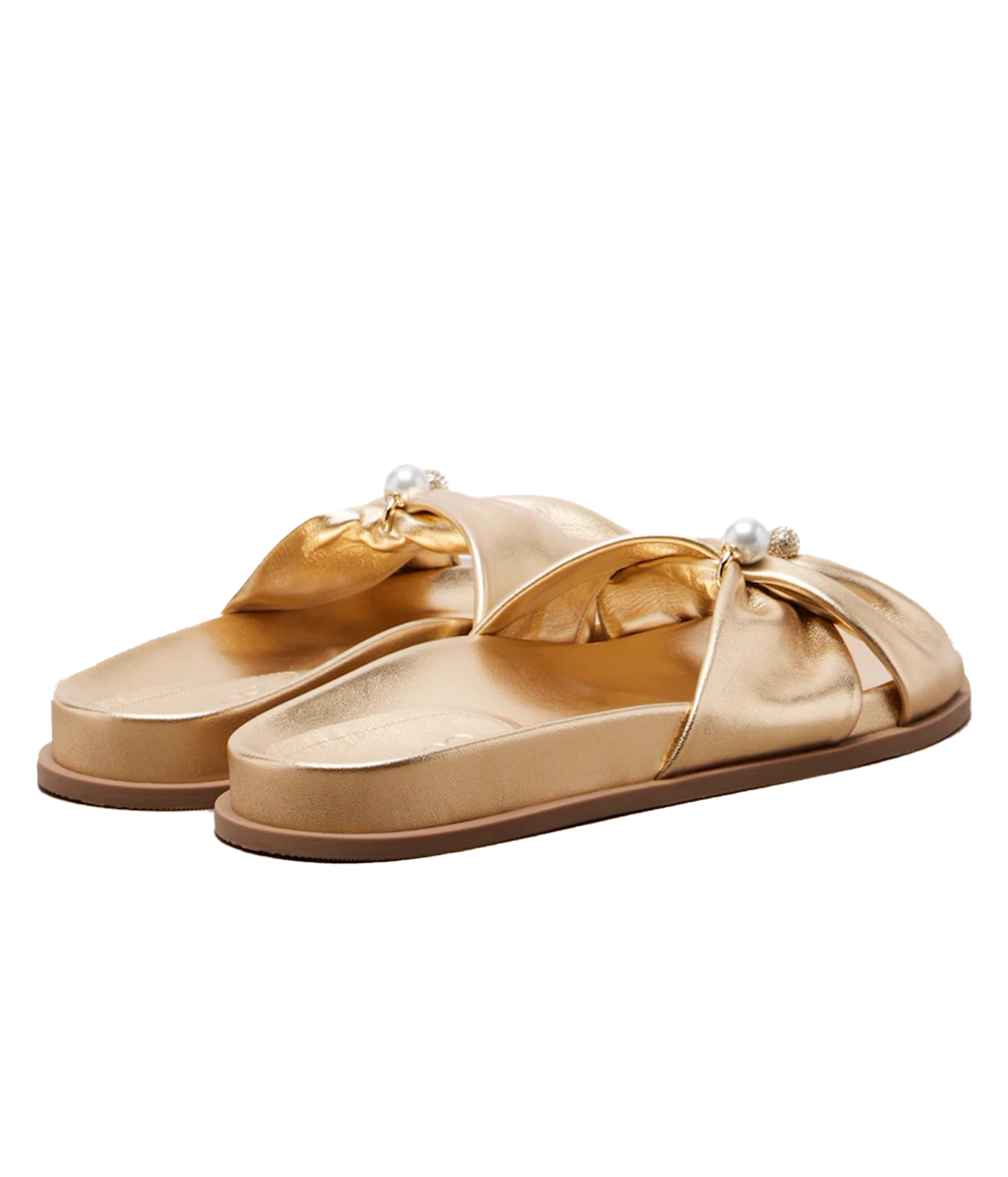 A pair of metallic gold slide sandals with wide crisscross straps, decorative fabric bows, and small pearl accents on the straps, shown against a plain white background.