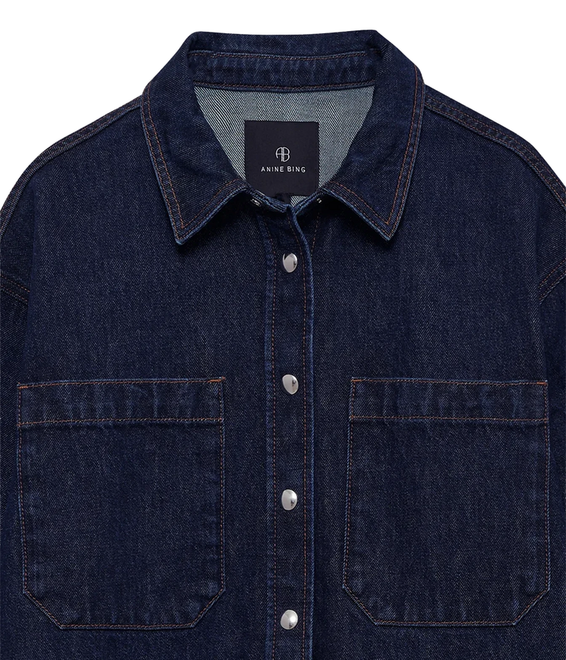 Close-up of the Anine Bing Samy Shirt in Unwashed Blue showing the collar, button front and chest patch pockets.