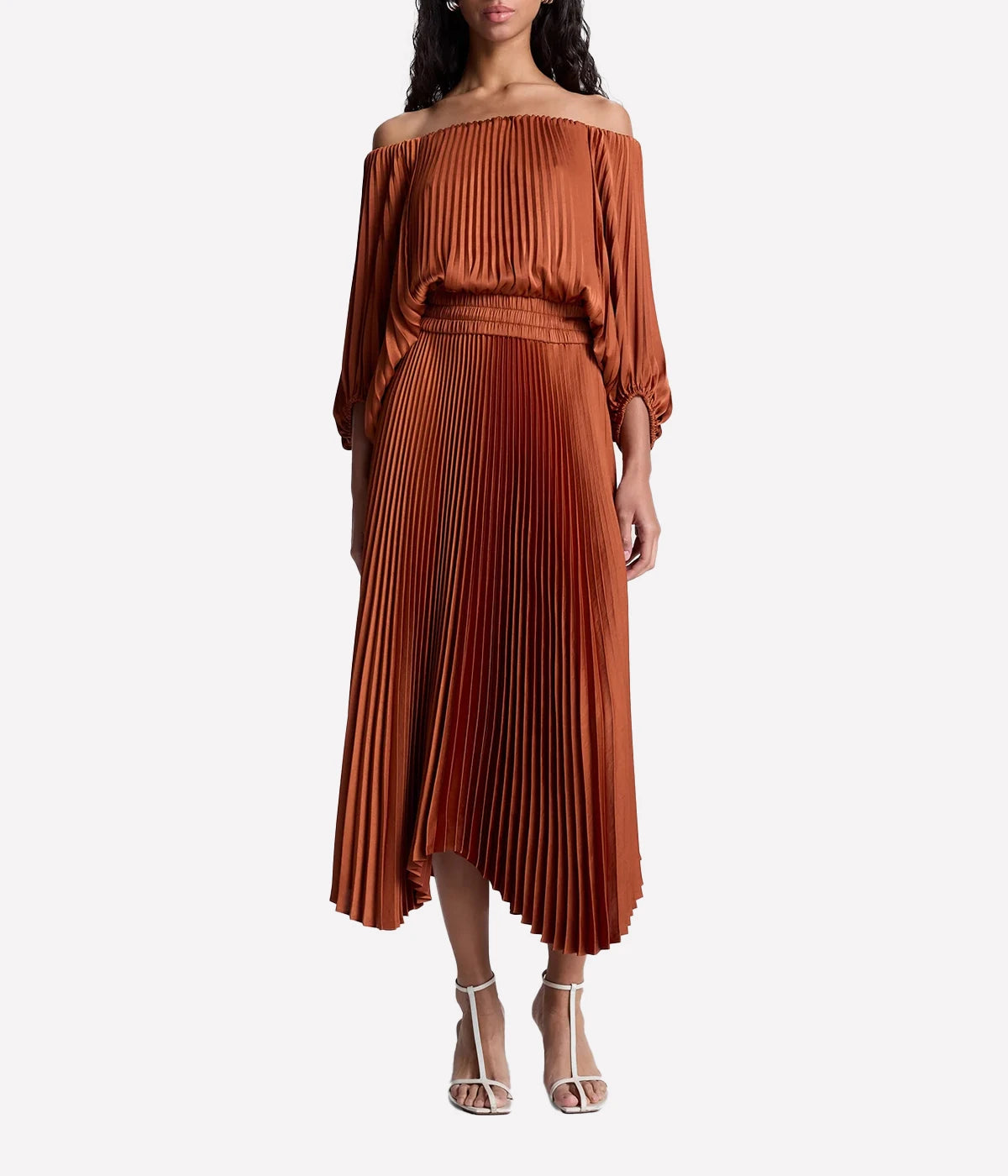 ALT text: Rust-red off-the-shoulder satin midi dress with pleated asymmetrical skirt and three-quarter voluminous sleeves.
