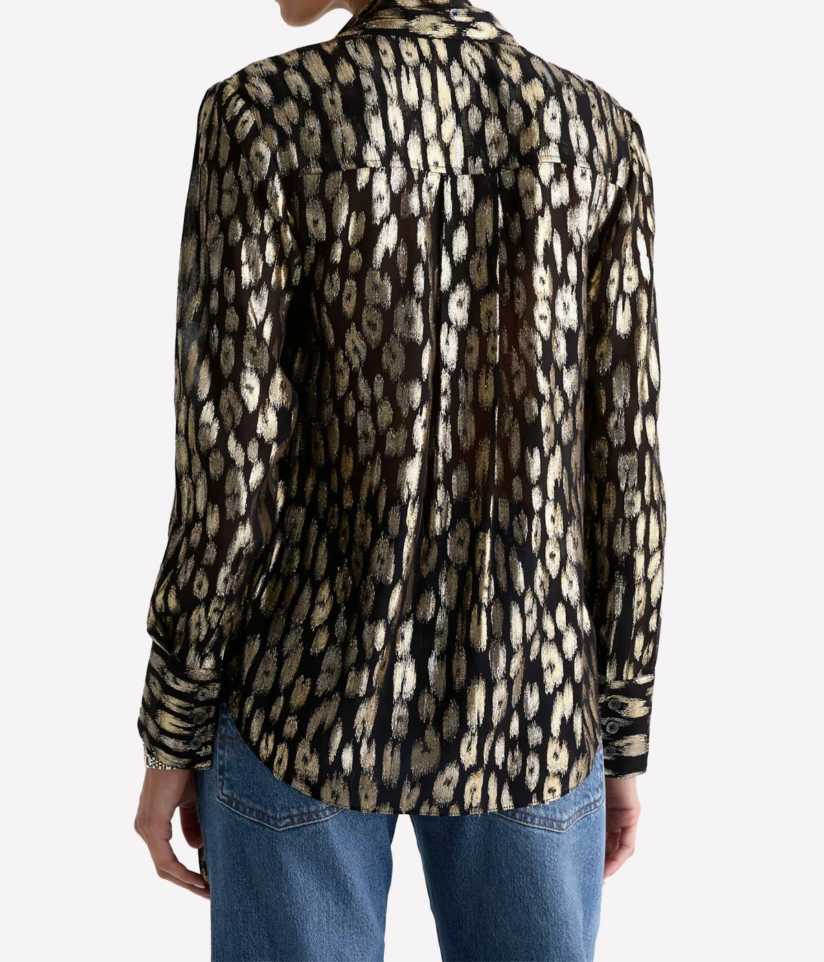 Back view of a model wearing the AG Lora Tie Neck Shirt in Leopard Lounge with blue jeans, showing the collar, long sleeves and relaxed fit through the back