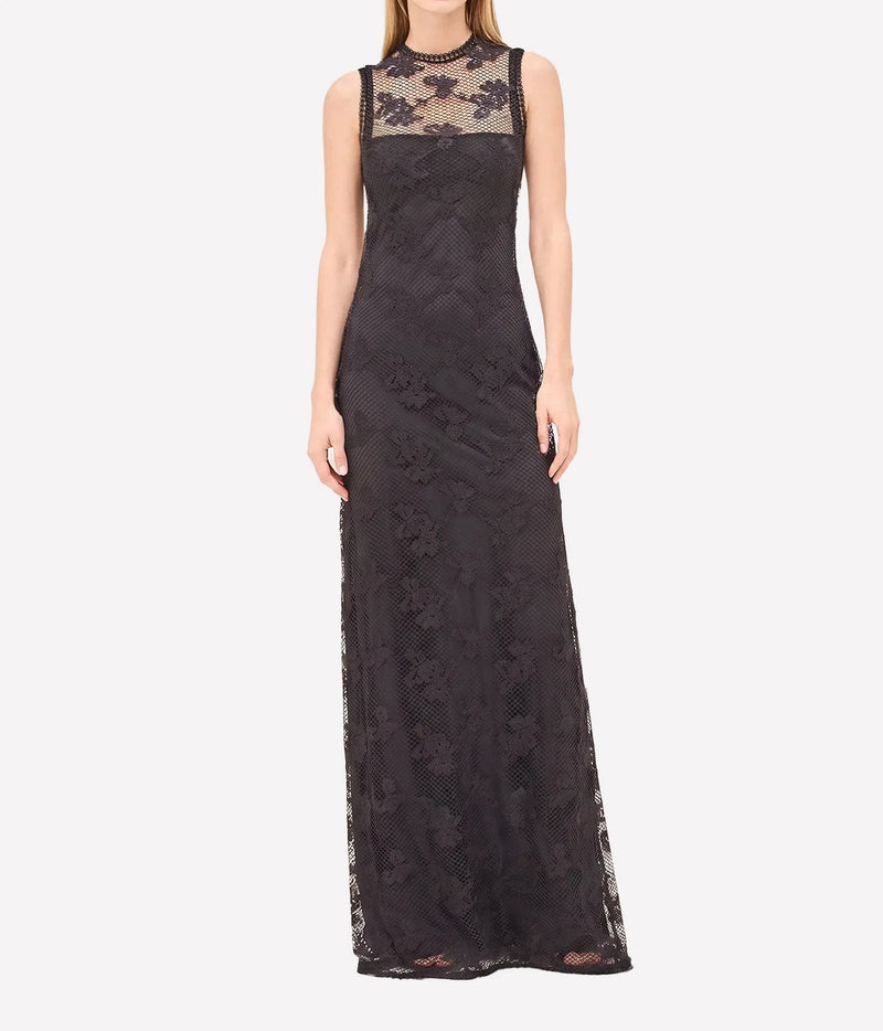 A sleeveless black lace maxi dress with a sheer high-neck bodice and floral lace applique, shown on a model against a light gray background.