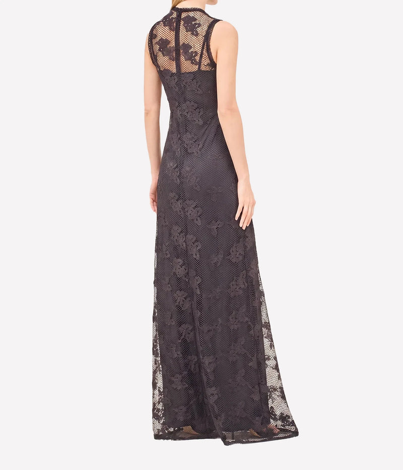 A sleeveless floor-length lace gown shown from the back on a model, featuring a sheer mesh back panel and floral lace overlay, against a plain light gray background.