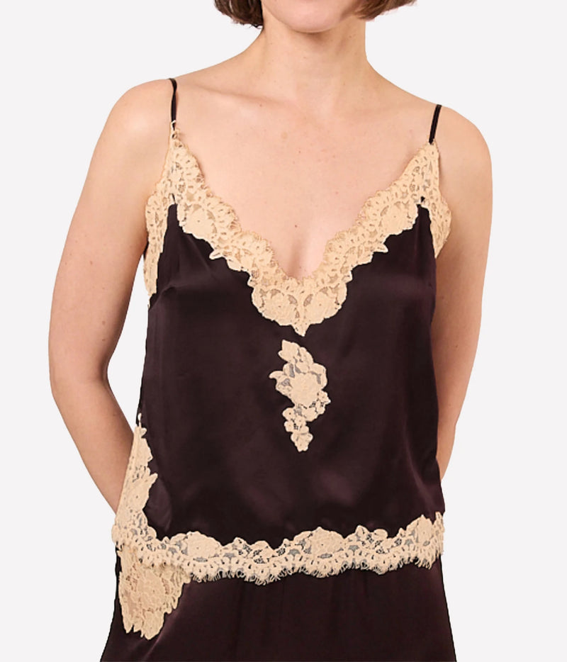 A close-up of a model wearing a dark brown satin camisole with beige lace trim along the neckline, underbust, and hem.