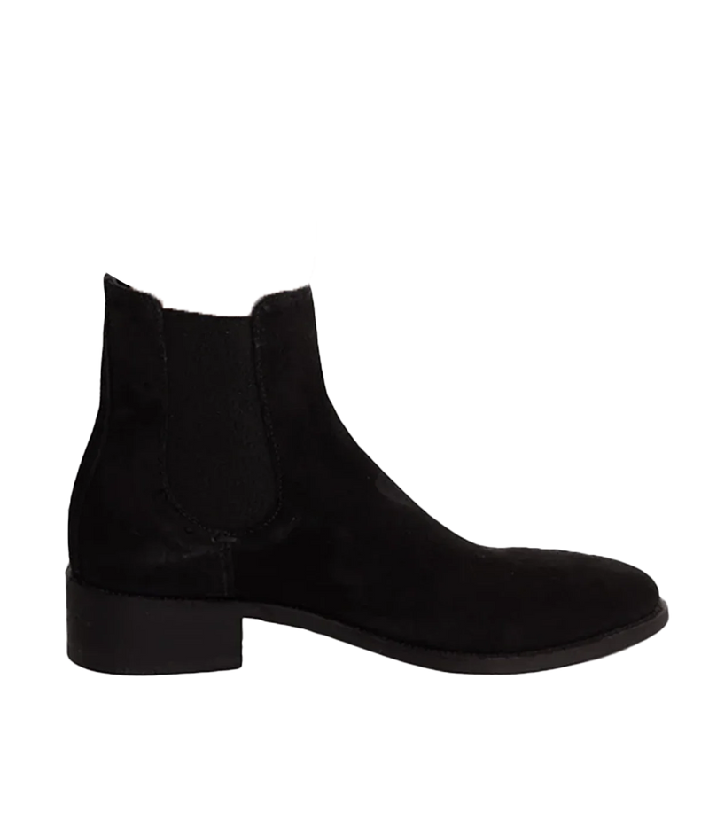 ALT Text: Officine Creative Seline Chelsea boots in jet-black suede leather with a rounded almond toe, side stretch fabric inserts, tone-on-tone grosgrain heel loop tab, and low stacked heel.