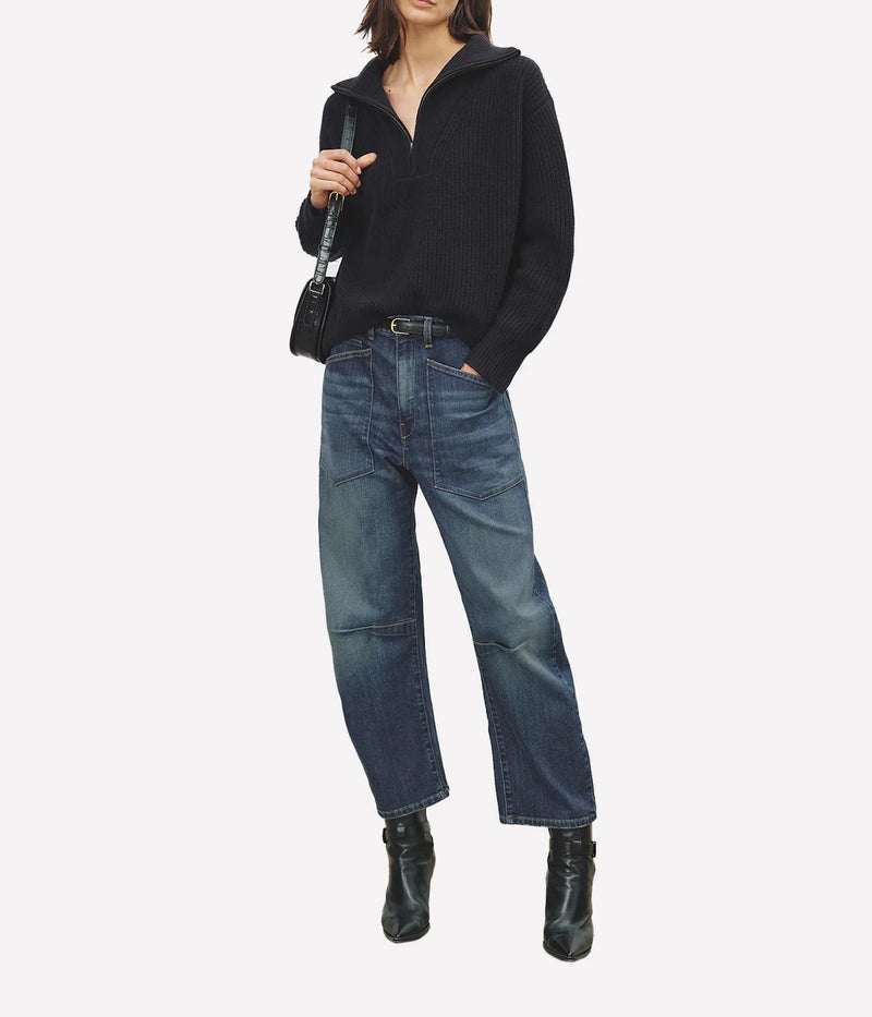 Full length view on model showcasing Nili Lotan Shon Jean featuring a mid-rise waist and relaxed barrel-leg silhouette in Japanese stretch denim. 