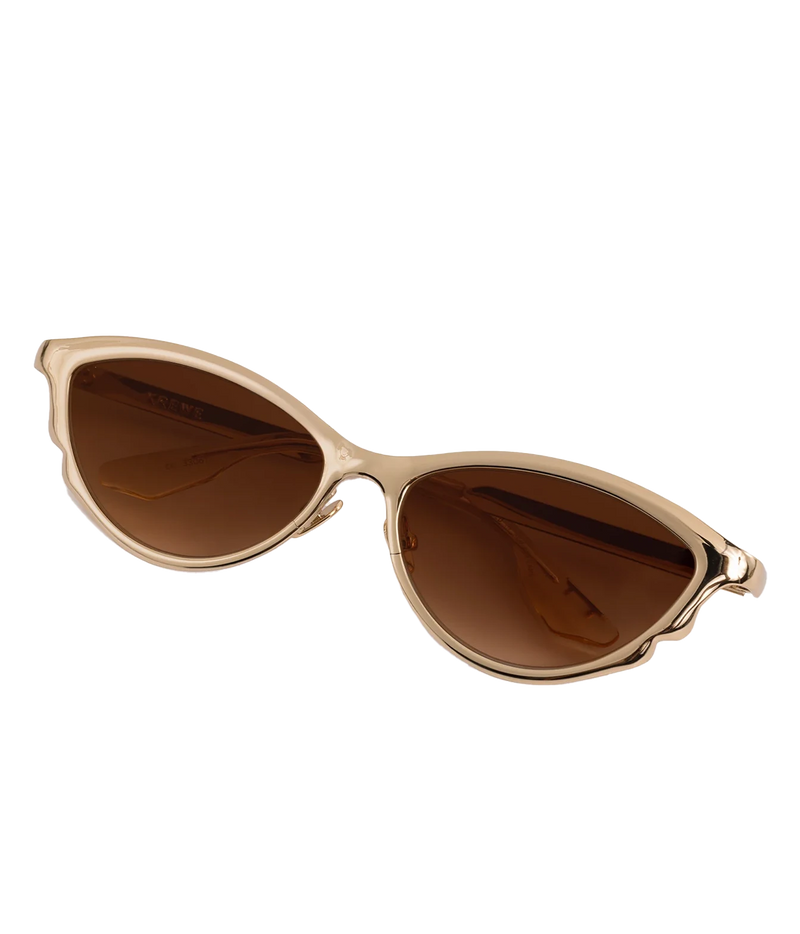Angled view of the KREWE Solange Sunglasses in 18K Chroma Champagne, showing the mirrored gold frame and slim metal temples