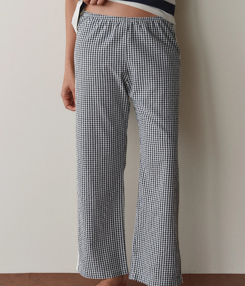 Model wearing navy gingham check pants, side profile view showing the straight-leg fit.