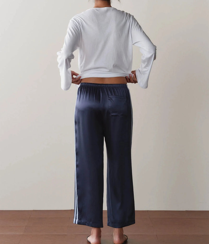DONNI Silk Stripe Crop Pant in Navy Cloud, fluid silk charmeuse drape, full-length back view on model
