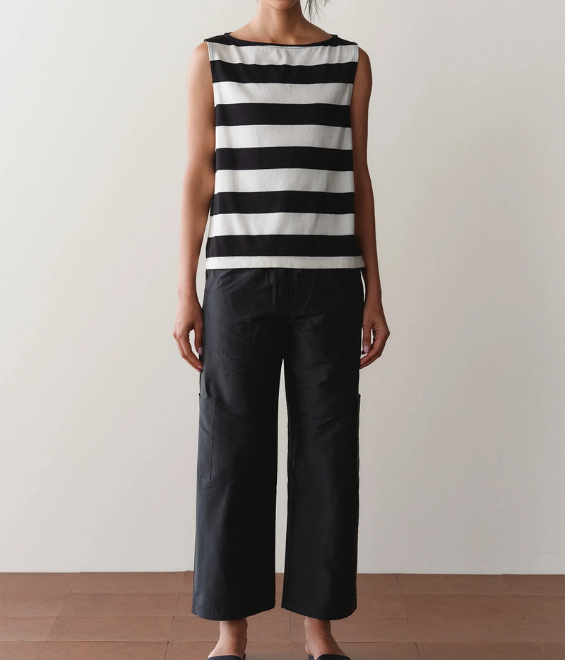Model wearing black cargo pants with a striped tank top, front view showing the relaxed straight-leg fit.
