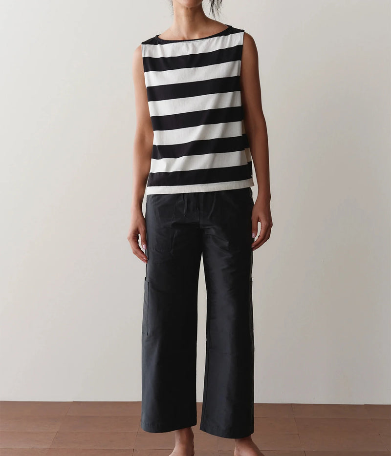 Model wearing black cargo pants with a striped tank top, front view showing the drawstring waist detail.
