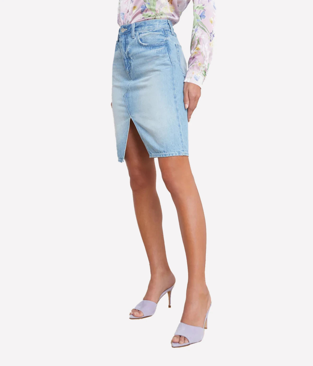 Vintage-inspired denim skirt with a split hem, styled with a linen blouse and sandals for a casual yet refined summer look.