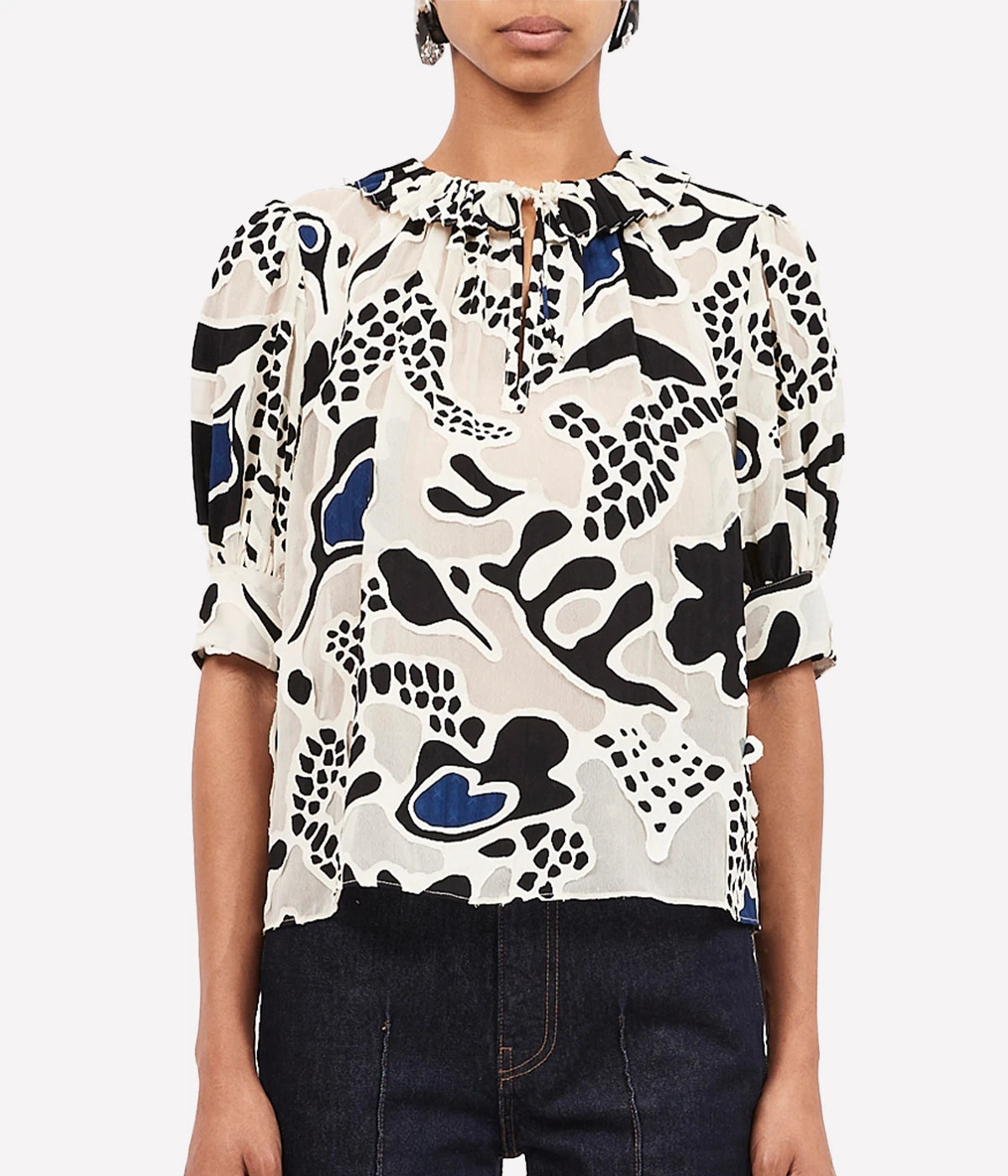 Flattering Silhouette: The short sleeves and flowy design make it easy to tuck into denim for a polished look.

Delicate Details: Accented with ruffles at the collar, this top offers versatility with neckties that can be left loose for a relaxed style or fastened for a keyhole front.

Styling Tips: Pair with high-waisted jeans and strappy sandals for an effortlessly chic daytime look, or tuck into a skirt and elevate with heels for a sophisticated evening outfit.