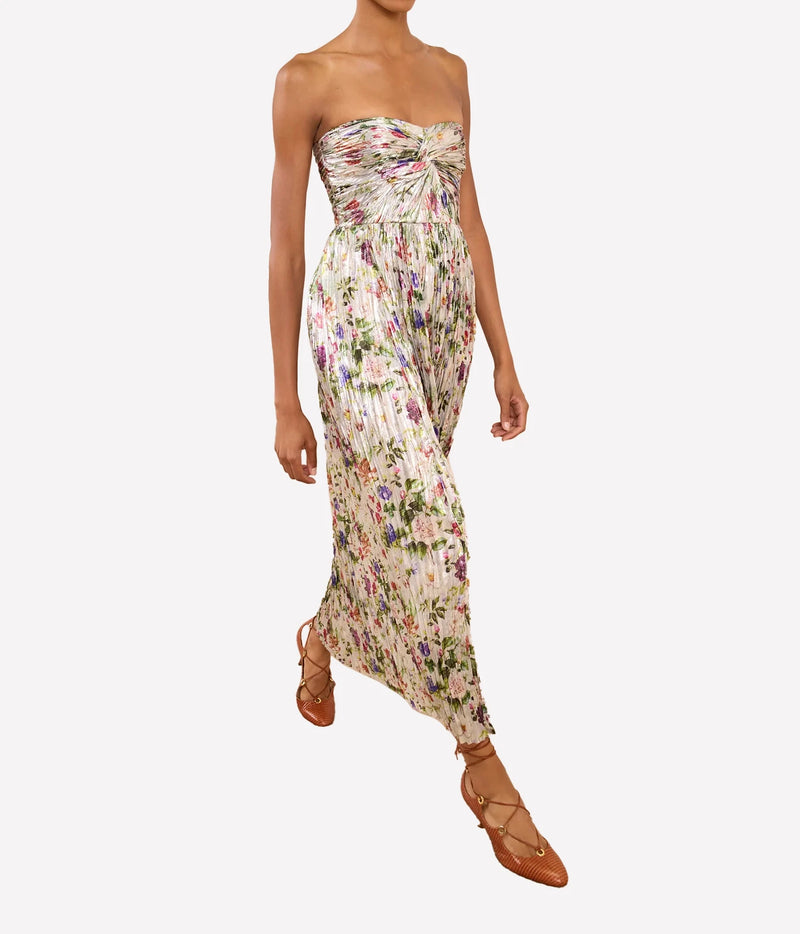 Model wearing Ulla Johnson Adelaide Strapless Pleated Dress in Sterling Floral while walking