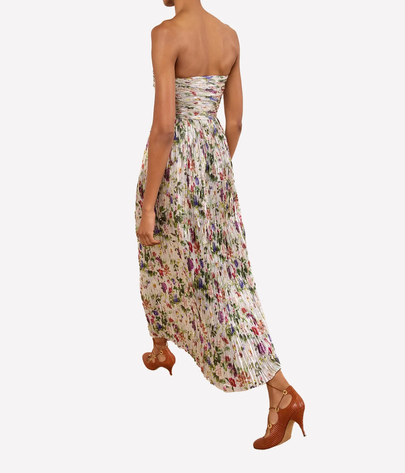 Model wearing Ulla Johnson Adelaide Strapless Pleated Dress in Sterling Floral, back view