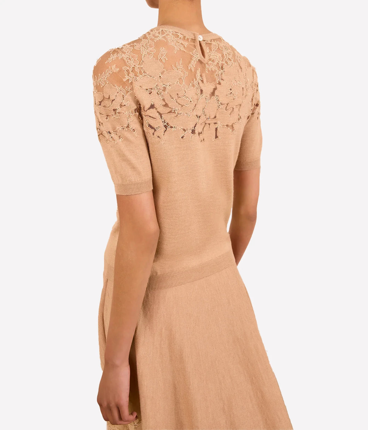 Model wearing Ulla Johnson Ella Short Sleeve Lace Top in Almond, back view