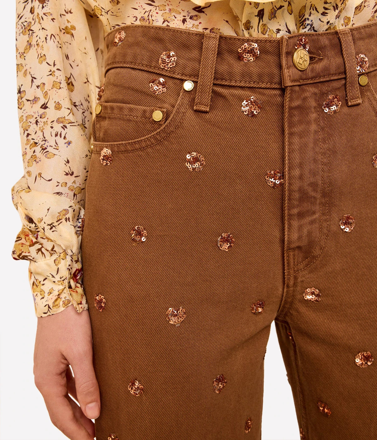 Close-up of Ulla Johnson The Willow Embellished Wide Leg Jean in Umber floral embellishments and front pockets