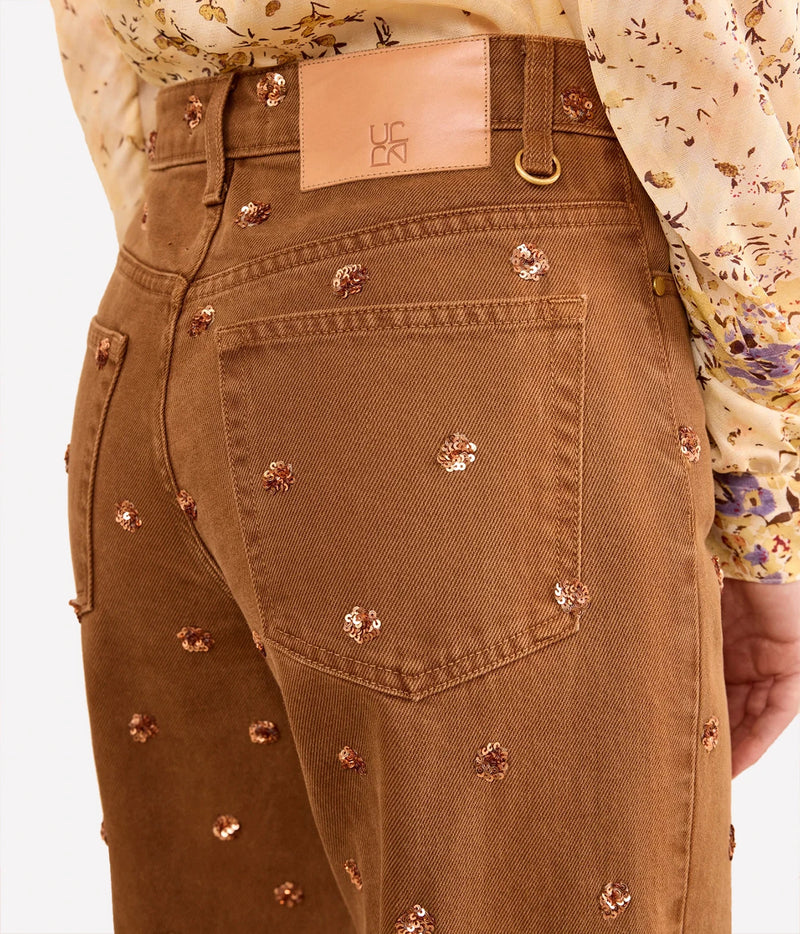 Close-up of Ulla Johnson The Willow Embellished Wide Leg Jean in Umber back pocket and embellishments