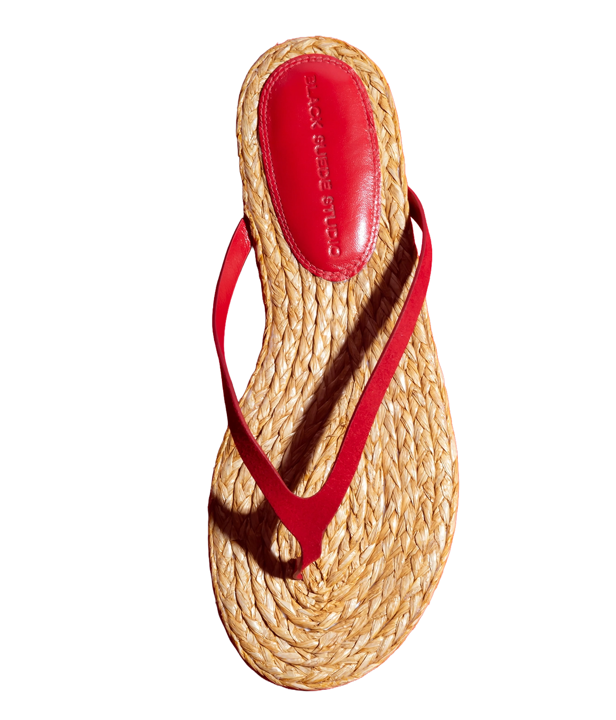 A single woven straw thong sandal with a bright red strap and red insole - Alaya Sandal in Cherry Suede