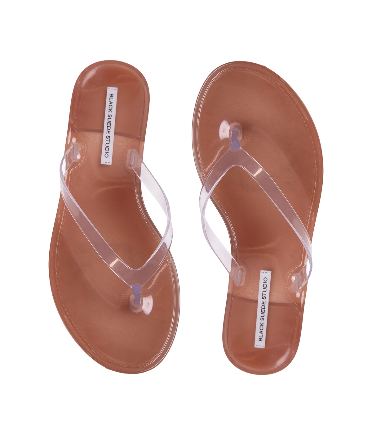 A pair of transparent thong sandals with brown footbeds - Crystal Sandal in Old Rose