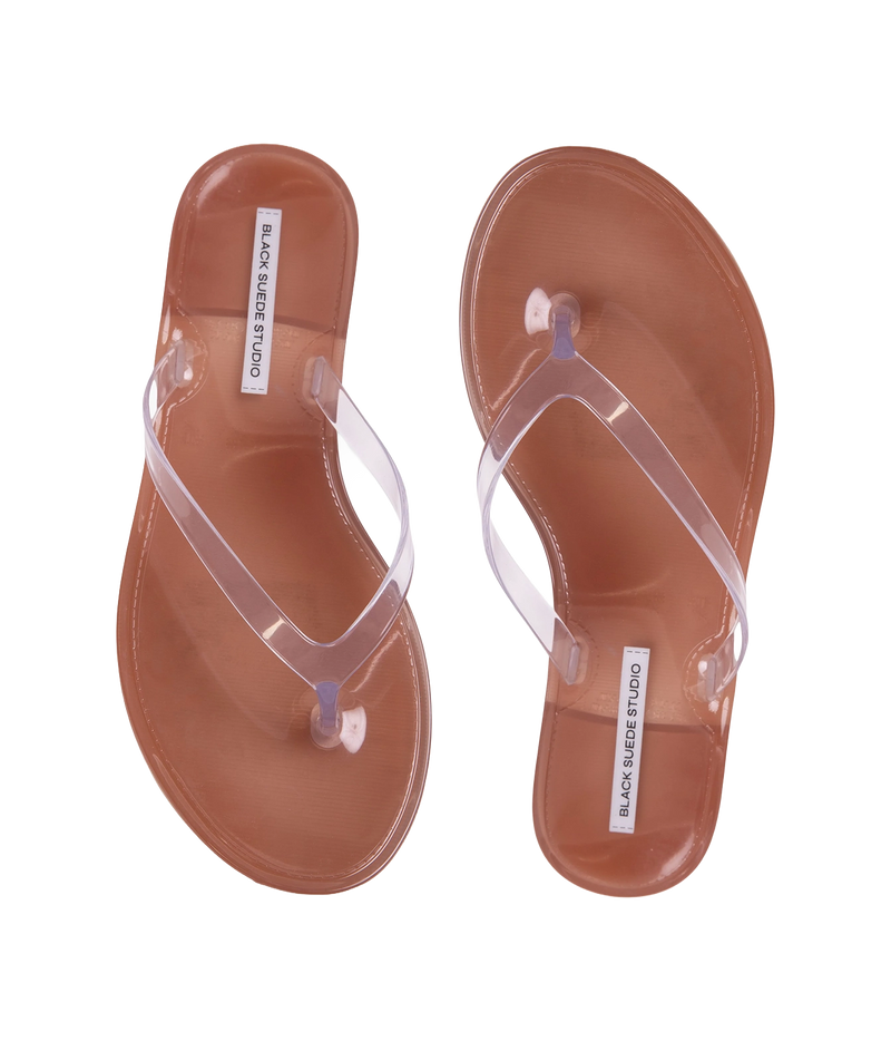 A pair of transparent thong sandals with brown footbeds - Crystal Sandal in Old Rose