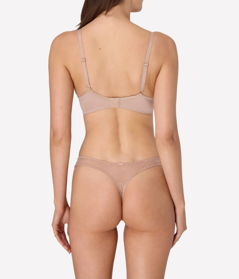 Model wearing the Anemone Thong in Nude with matching bra, back view.