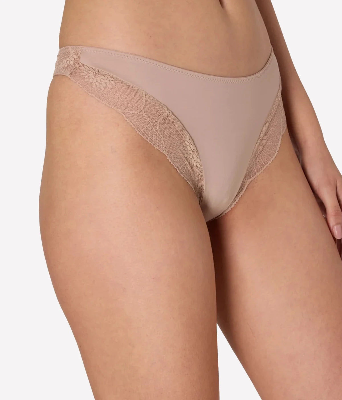 Model wearing the Else Lingerie Anemone Thong in Nude, front close-up.