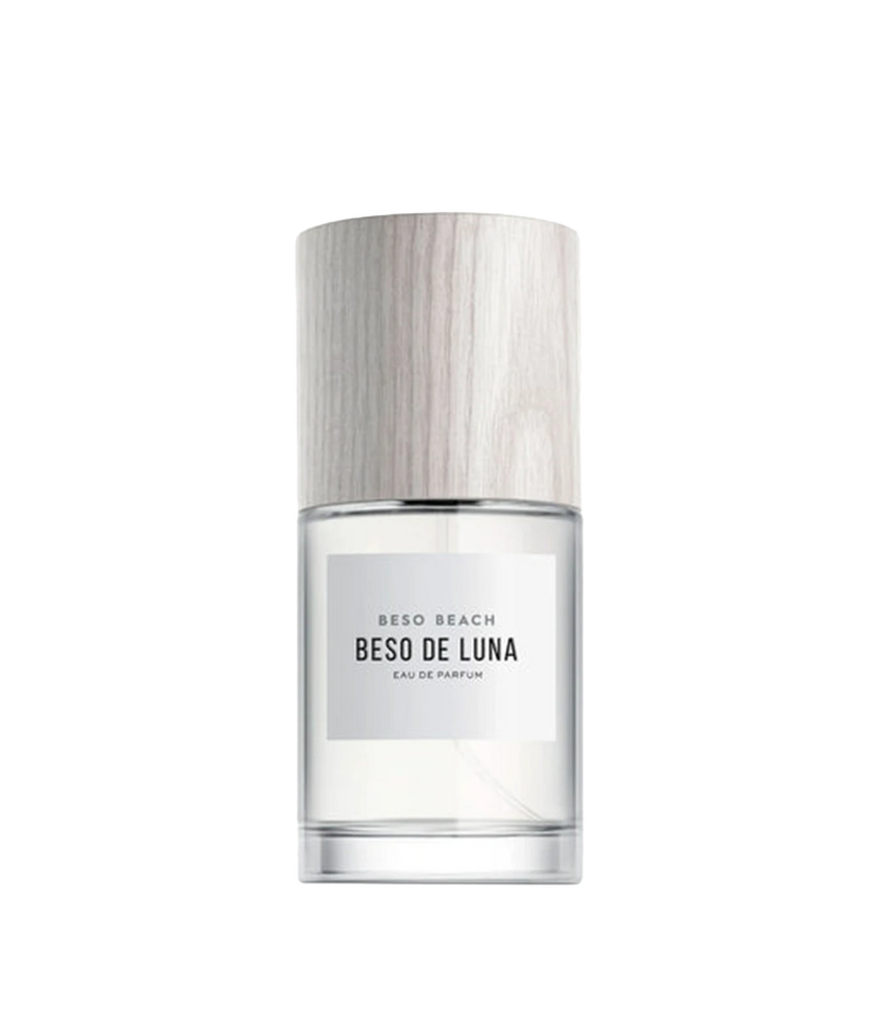 Beso Beach Beso de Luna Eau de Parfum in a clear glass bottle with a light wood-textured cap and a minimalist white label.