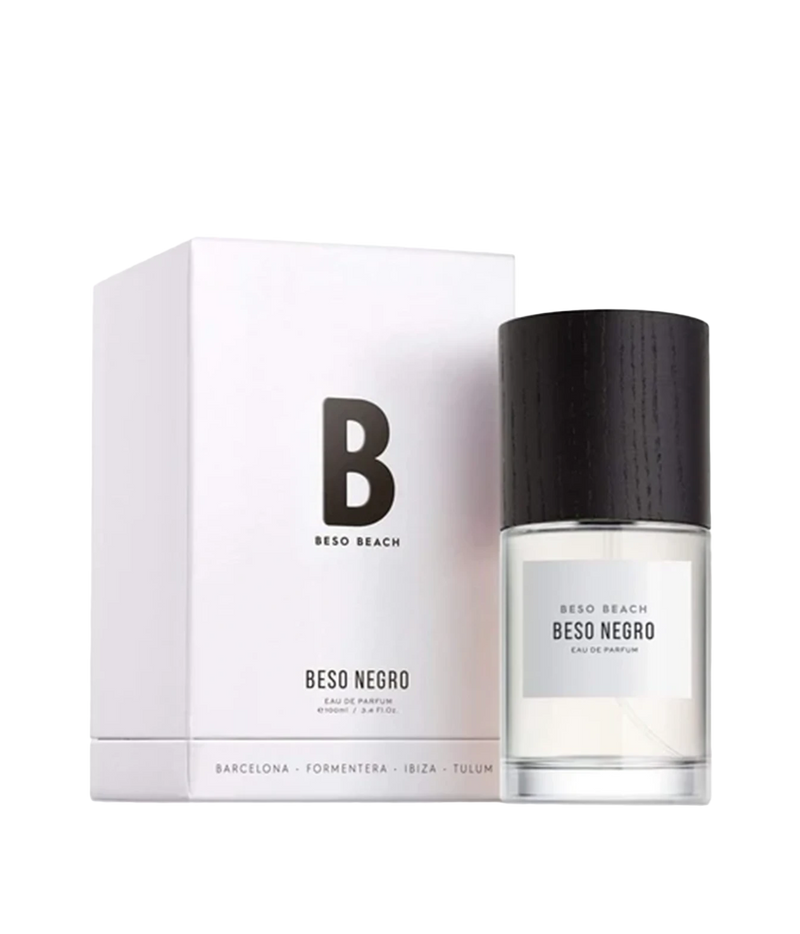 Beso Beach Beso Negro Eau de Parfum bottle with a black cap next to its white packaging box, featuring a minimalist black 'B' logo on a clean white background.
