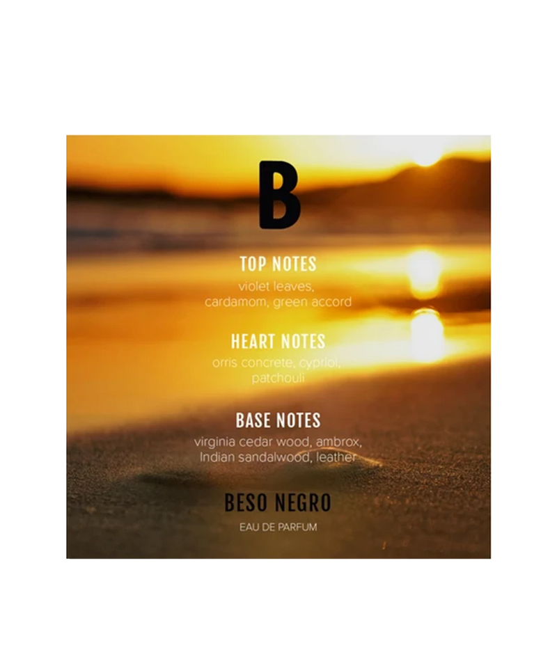 A square fragrance card for Beso Negro Eau de Parfum, featuring a warm golden sunset beach scene with white and black text detailing the scent notes.
