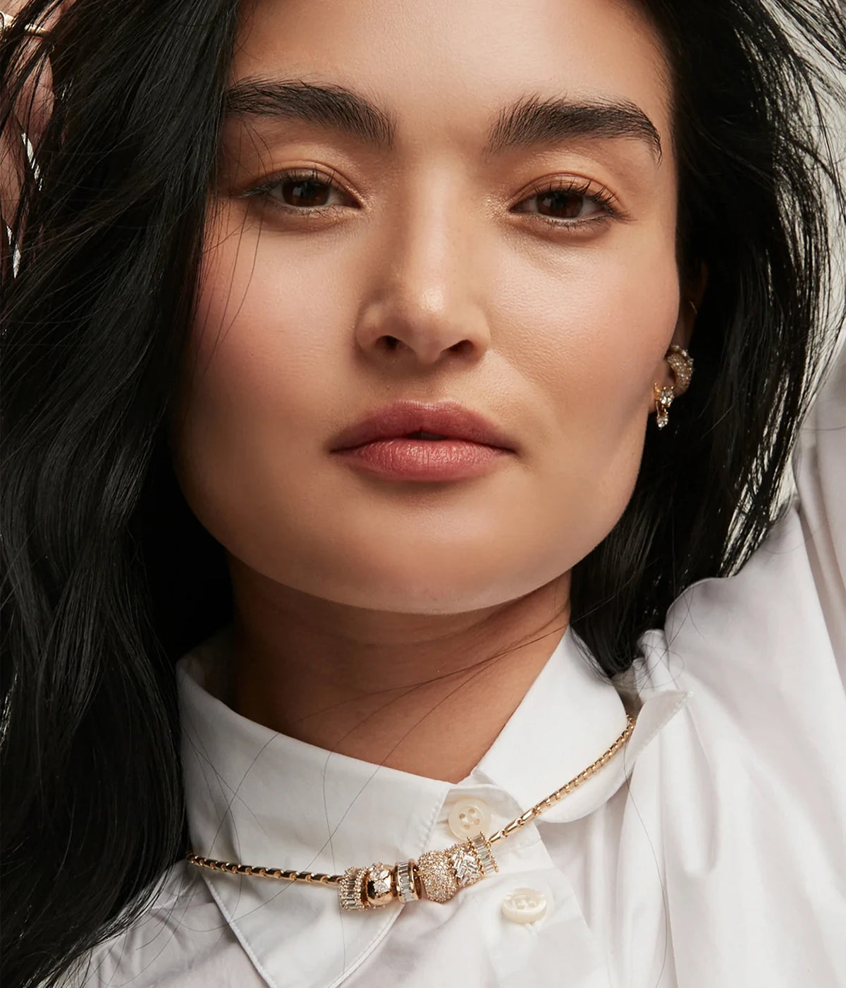 Model in a white collared shirt wearing the Adina Reyter Diamond Prong Set Baguette Big Bead in 14K Yellow Gold on a gold chain at the neckline