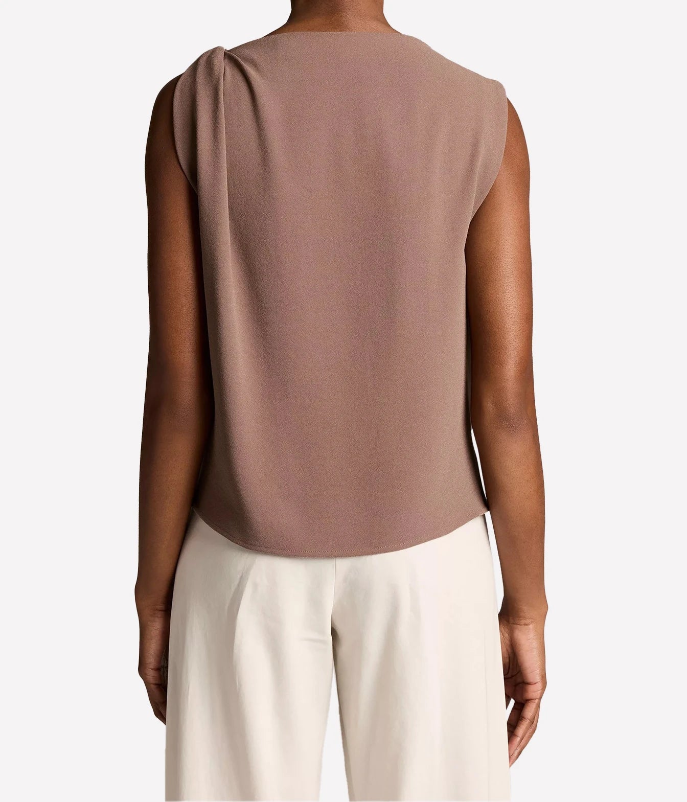 Rear view of a woman wearing a sleeveless dusty mauve top