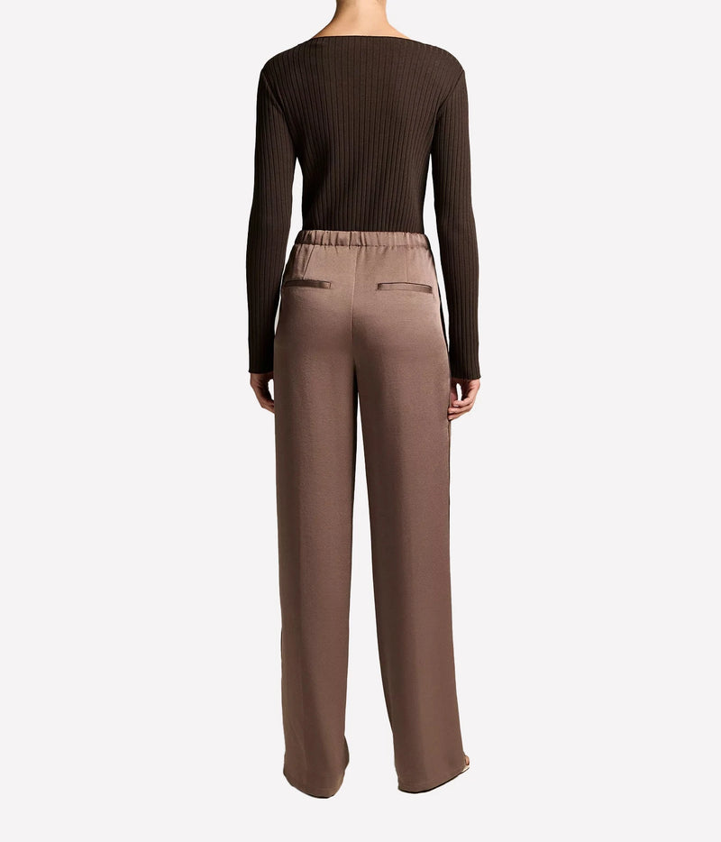 A model shown from the back wearing a dark brown ribbed long-sleeve top 