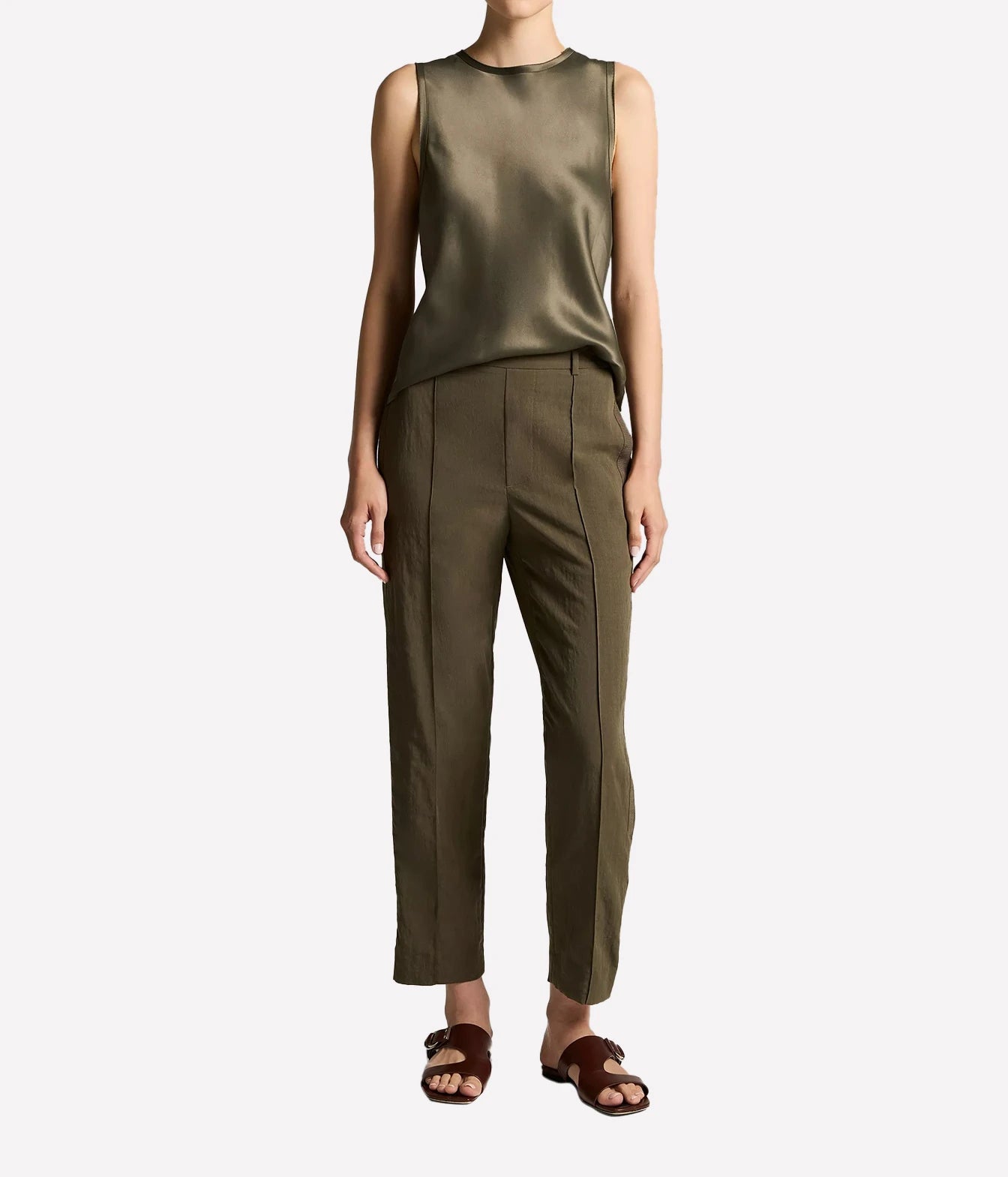 A model wearing an olive green satin sleeveless top 