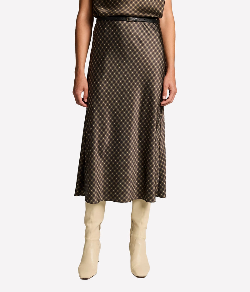 Front view of a model wearing the Vince Ombre Plaid Skirt In Black Camel with a thin black belt and cream knee-high boots, showing the bias-cut midi length