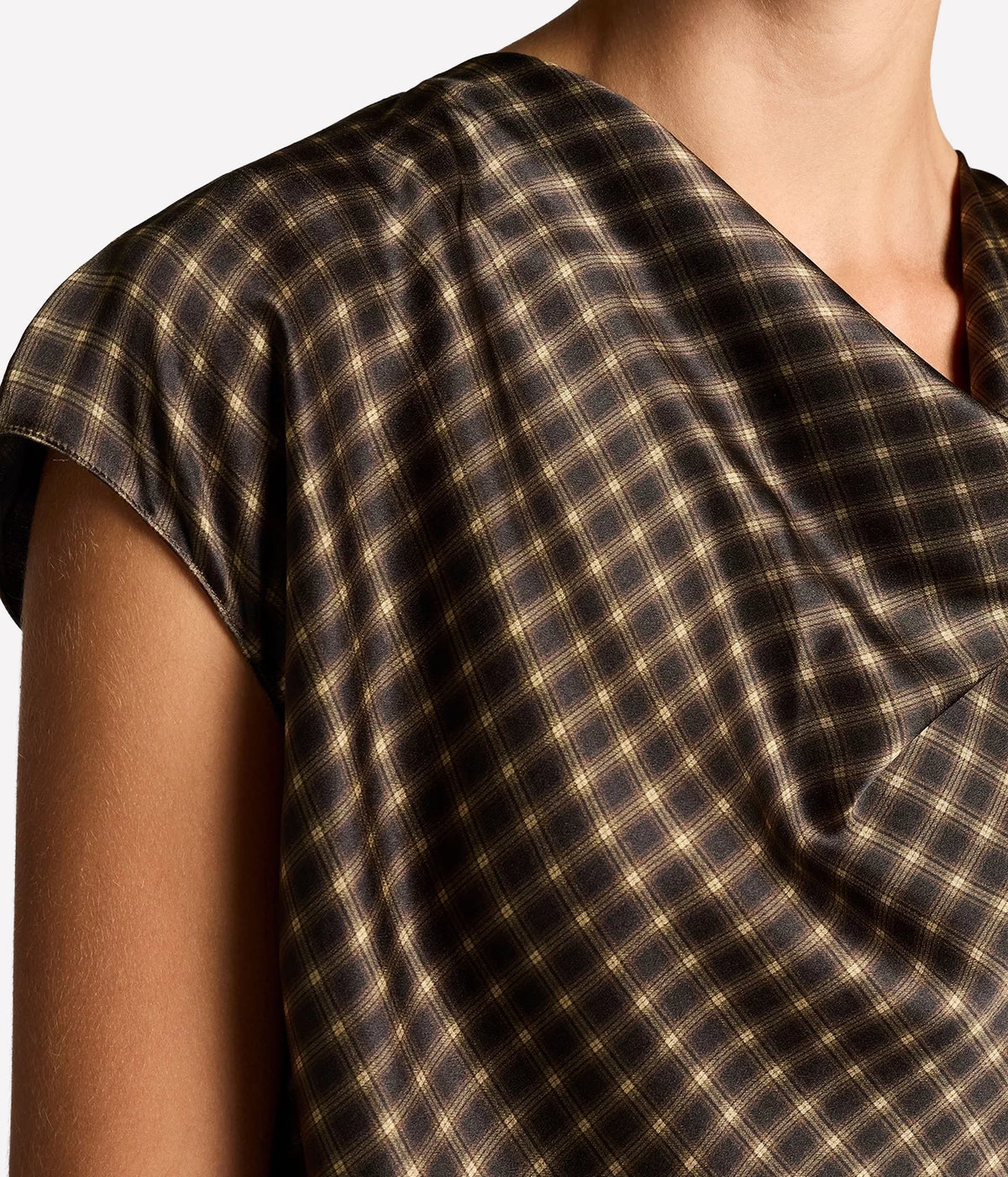 Close-up of the Vince Ombre Plaid Blouse In Black Camel showing the soft cowl neck drape, cap sleeve and plaid print