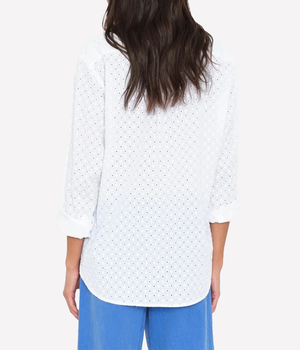 A model wearing white long-sleeve button-up shirt with a textured, eyelet-like woven pattern, shown from the back