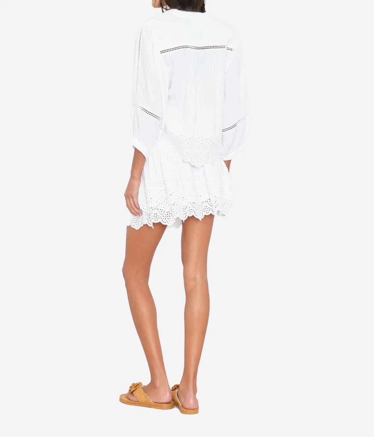 Model wearing the Xirena Roxana blouse in white and matching Xirena Rima Skirt in White with eyelets
