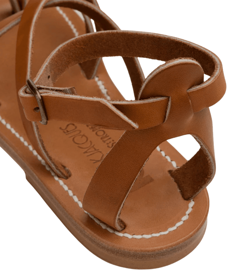 Brown sandal with 'Lacoste' branding on a transparent background