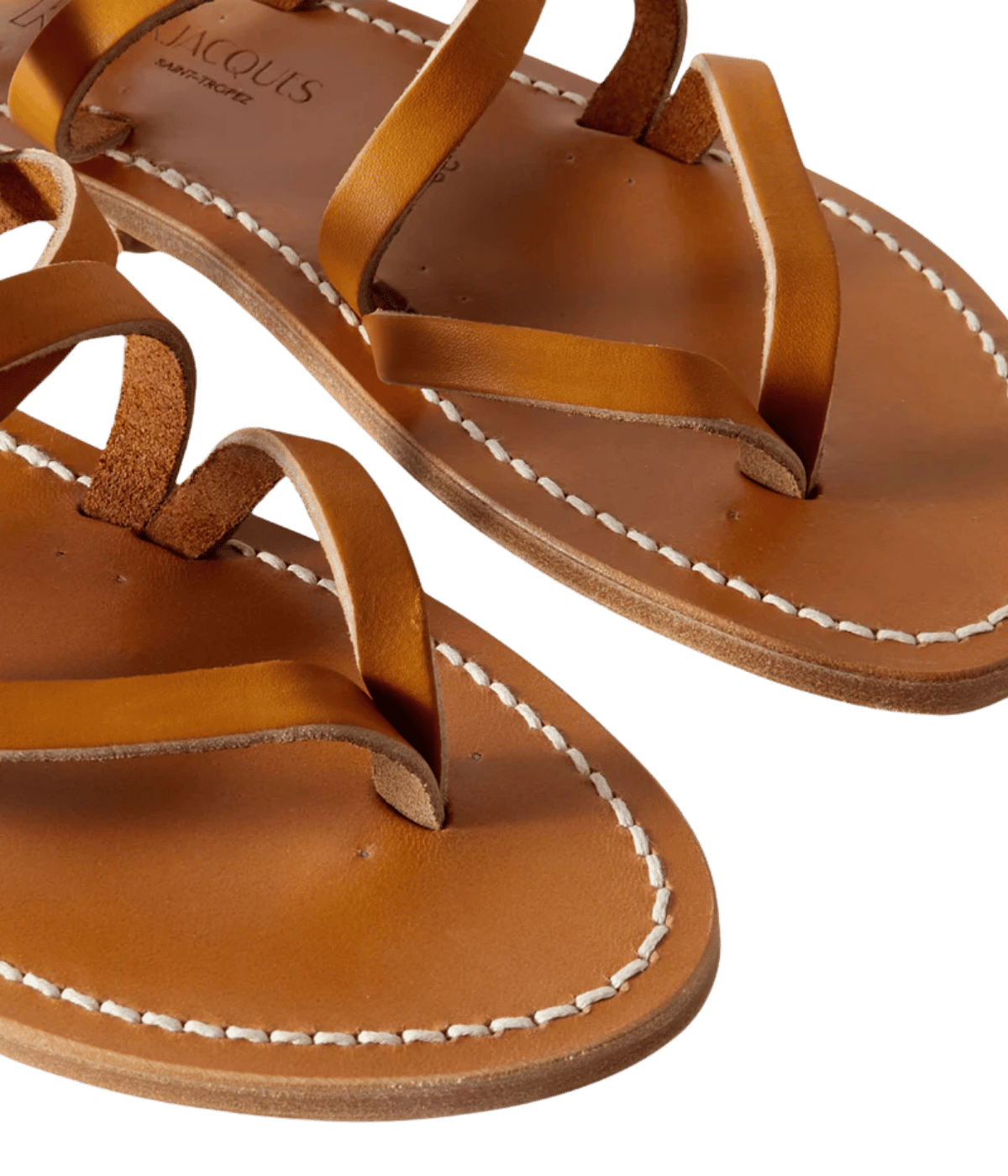 Pair of brown leather sandals with white stitching on a transparent background