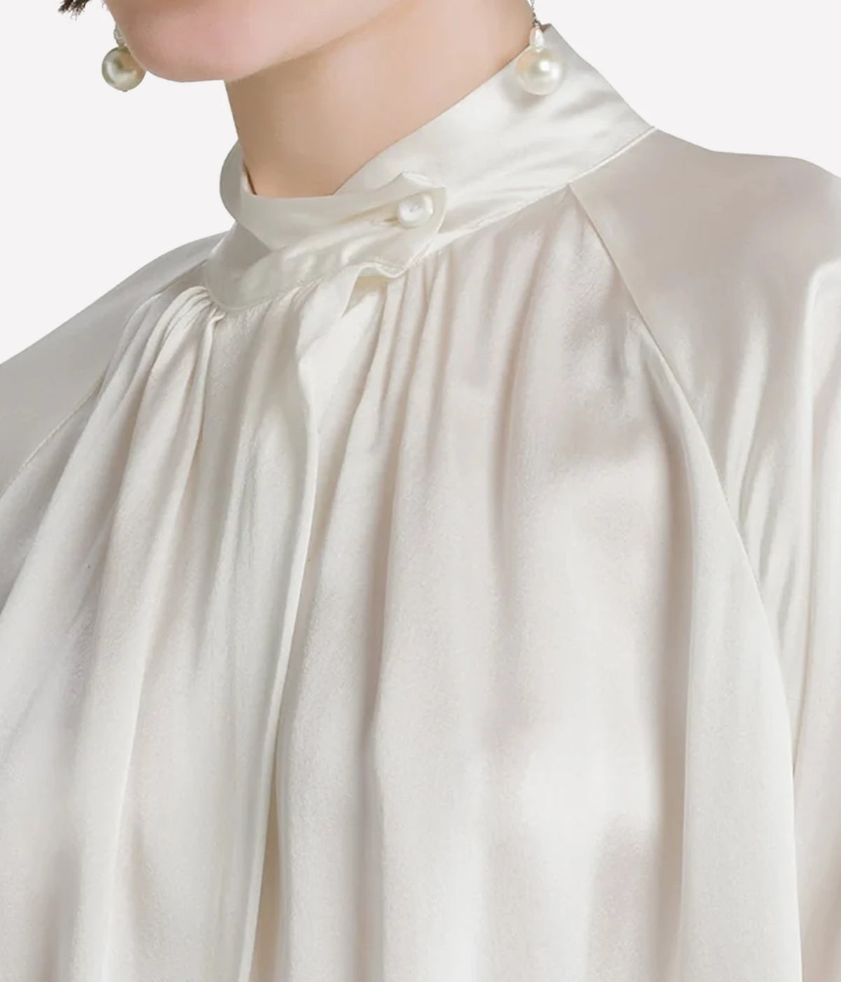 Close-up of the Forte Forte silk satin and plissé tulle dress in Diamond, showing the raised collar and satin bodice.