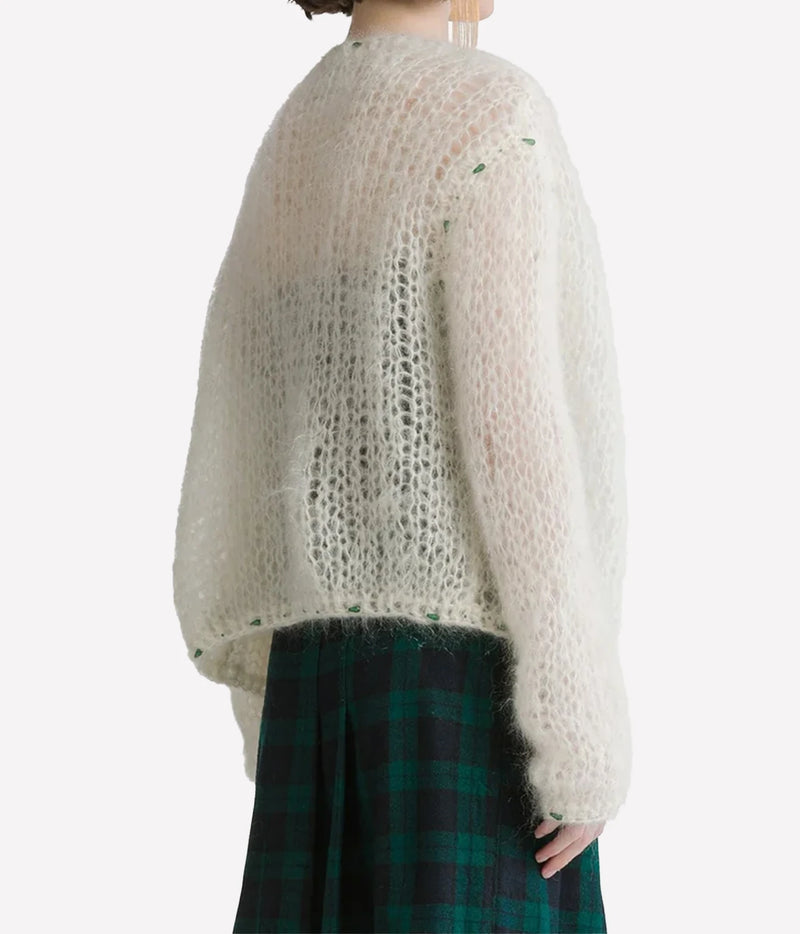 Side and back view of the Forte Forte mohair cardigan in Jewel Ivory, worn with a green tartan dress.