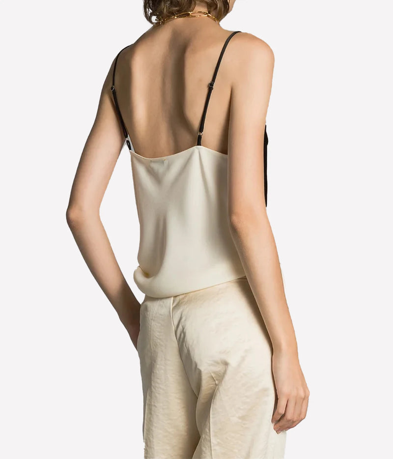 Back view of the Forte Forte satin and velvet slip top in Diamond, worn with cream trousers.
