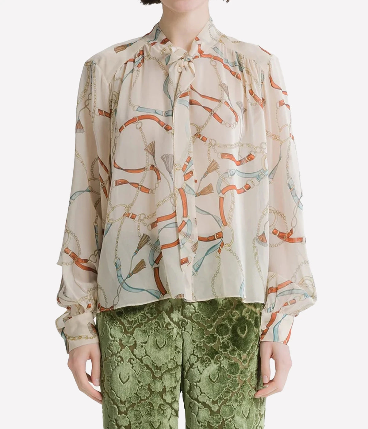 Woman wearing the Forte Forte crown print silk shirt in Ivory with green trousers, front view.