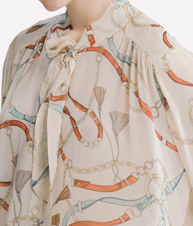 Close-up of the Forte Forte crown print silk shirt in Ivory showing the raised collar, tie sash and print detail.