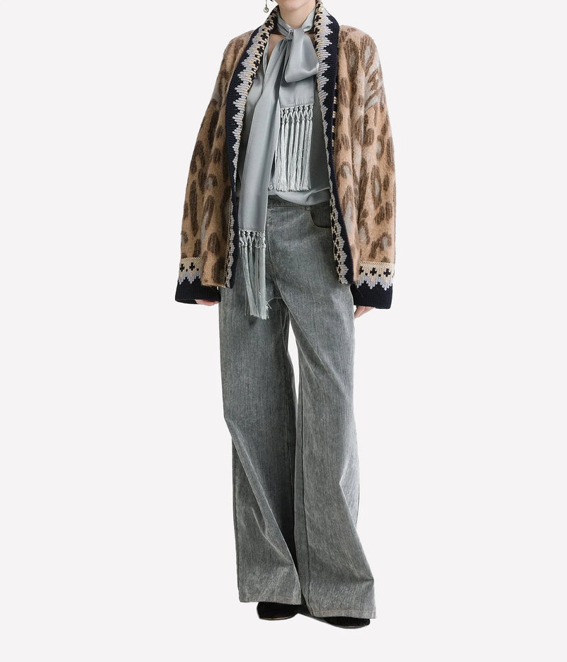 Woman wearing the Forte Forte Brit Leopard alpaca cardigan in Gold with grey wide-leg jeans, full-length front view.