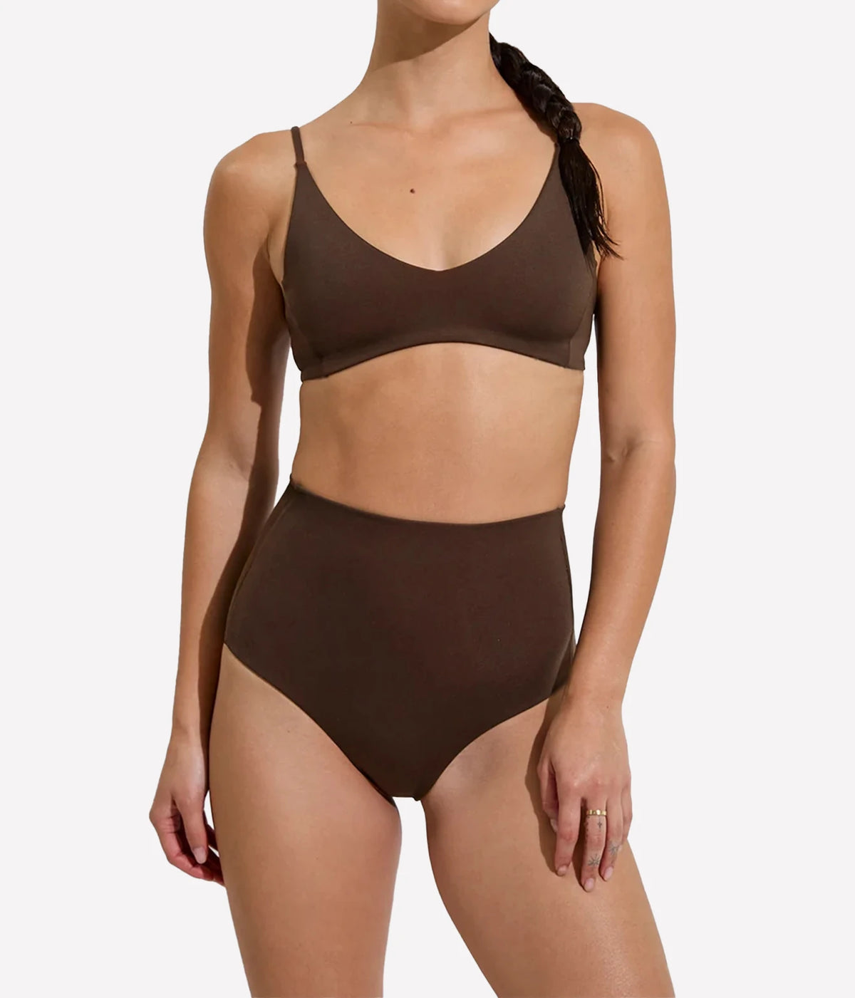 A woman modeling a two-piece bikini set in a solid dark brown color, featuring a scoop-neck top and high-waisted bottoms, Hi Tide Bottom In Cold Brew