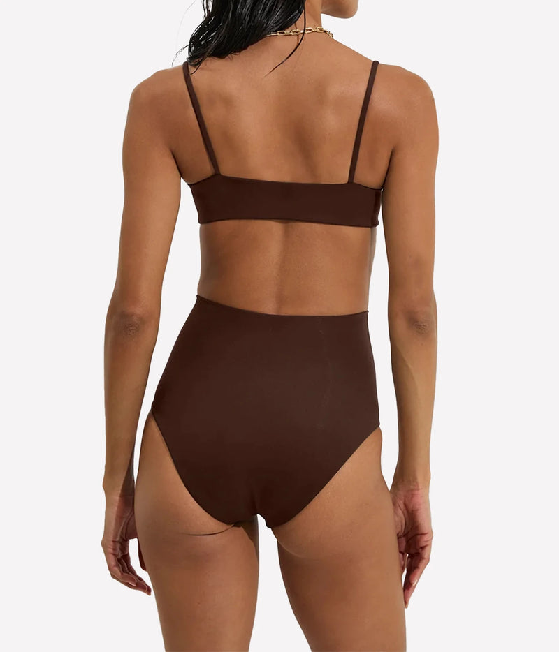 Rear view of a model wearing a dark brown two-piece swimsuit with a bandeau-style top and high-waisted bottoms - Hi Tide Bottom In Cold Brew