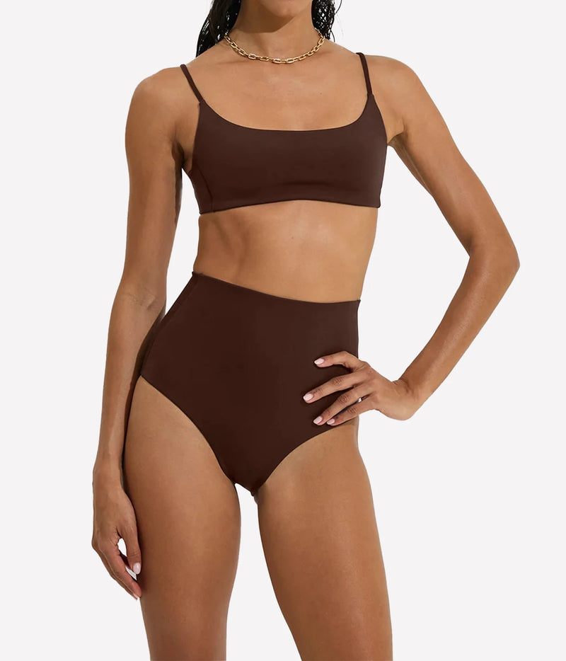A woman modeling a two-piece bikini set in a solid dark brown color, featuring a scoop-neck crop top and high-waisted bottoms, Hi Tide Bottom In Cold Brew