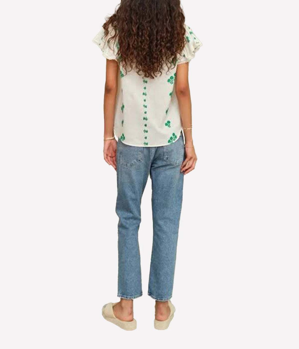 Model wearing the M.A.B.E Iris Woven Frill Short Sleeve Top in Green with denim – back view